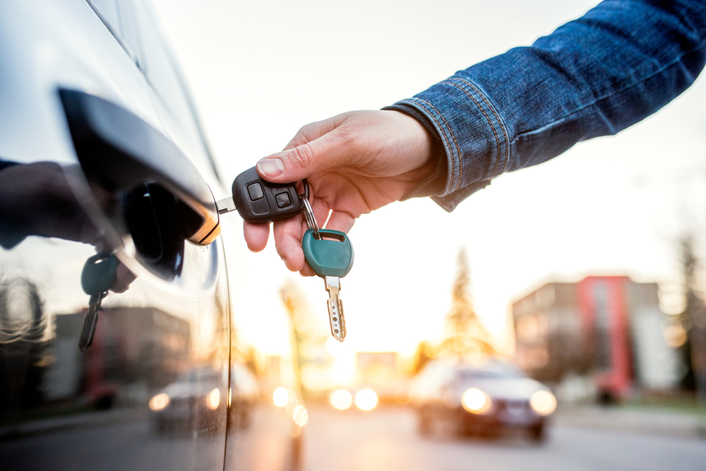 Guy opening a car with keys