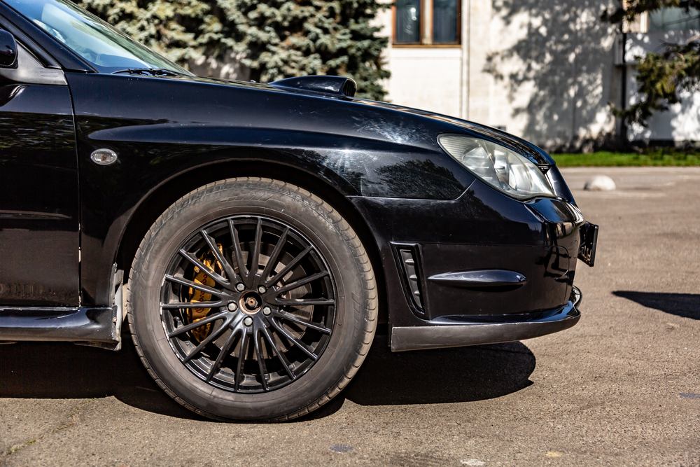 Black car in static on a sunny day.