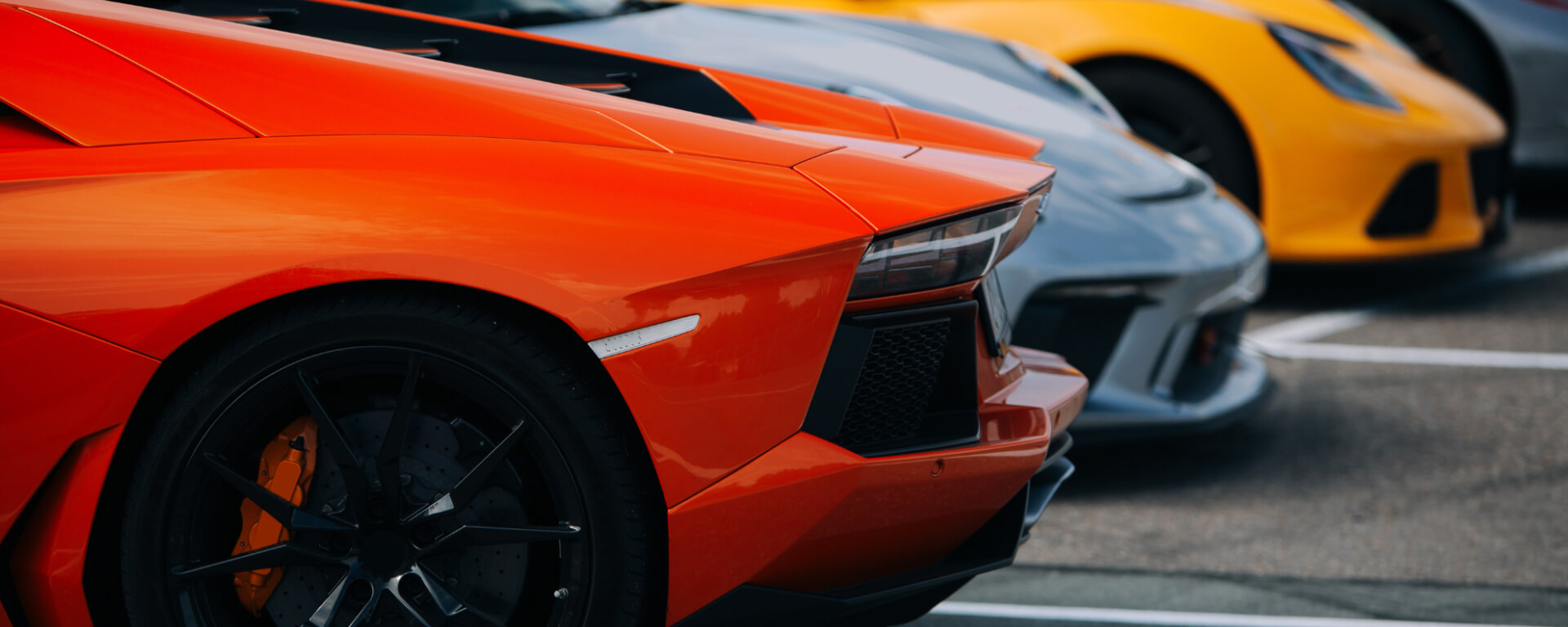 Different coloured performance cars parked together