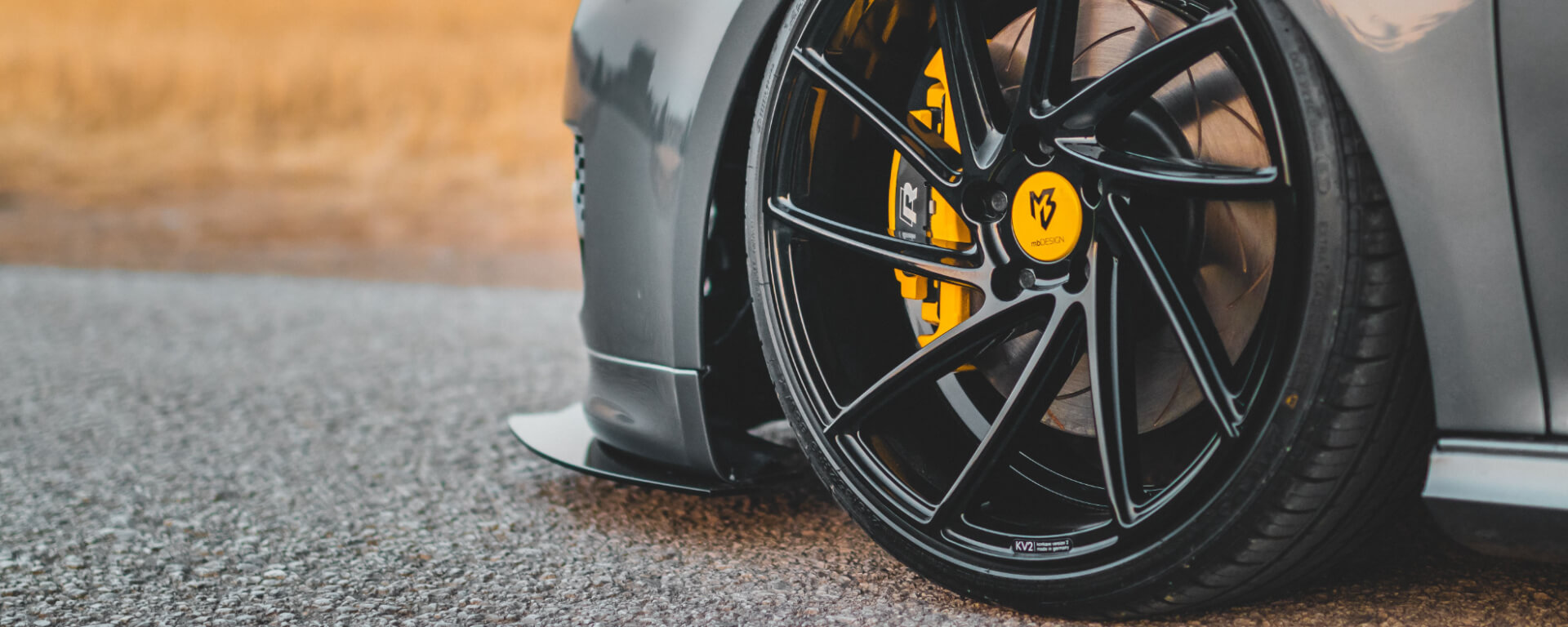 Grey VW with lowered suspension and yellow brake calipers